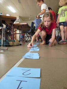 Pairs of grade 1-4 students located the hidden 1-100 cards and then put them in order.