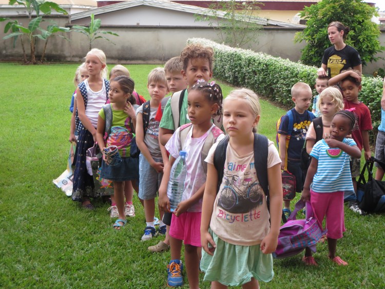 Kindergarten students (on right) and grade 1 & 2 students line up for class.