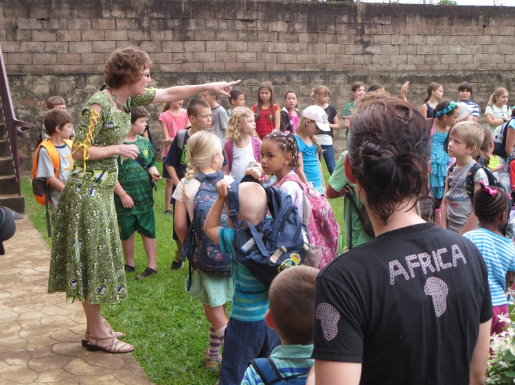 Mrs. Santos talks with students about where they can and cannot play at recess.