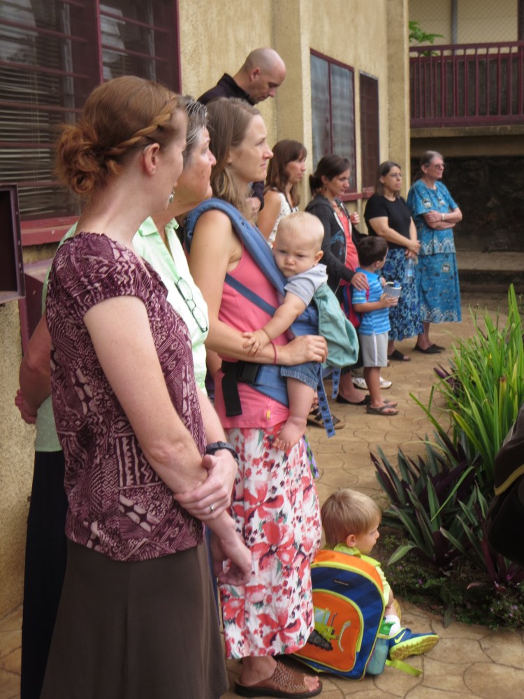 Parents and teachers listen to instructions on the 1st day of school.
